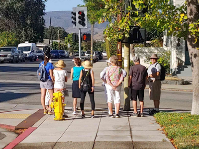 A group of seniors getting ready to cross the street for a morning walk