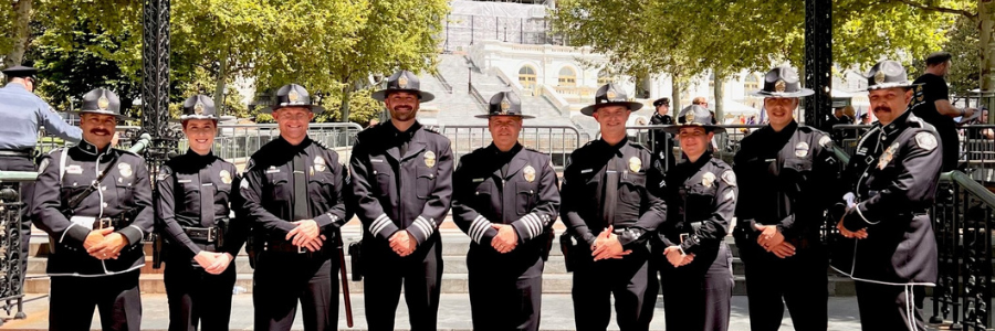 line of police officers smiling at the camera 