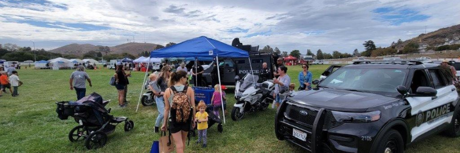 community members surrounding police tent for sheriffs day