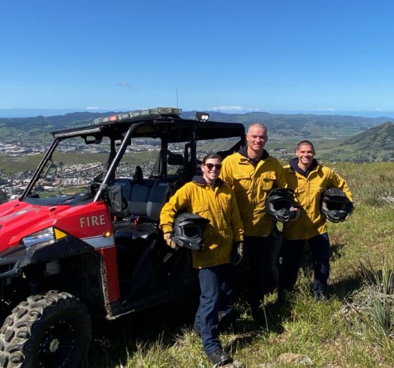 3 firefighters on hill with UTV