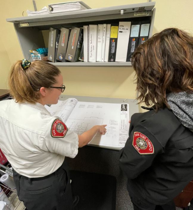 2 fire inspectors inspecting a plan