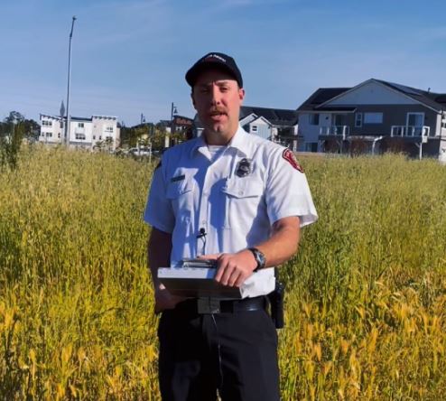 Fire inspector grass with a clipboard