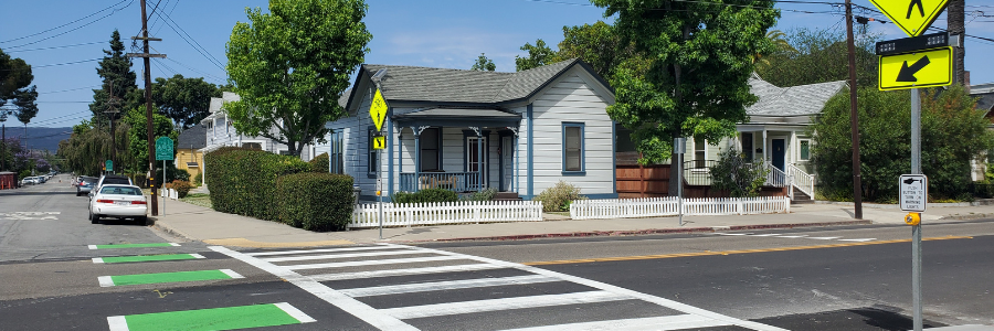 A picture of a pedestrian crosswalk with a rectangular rapid flashing beacon in a San Luis Obispo neighborhood