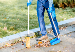 Sweeping leaves in the gutter