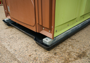 Close up of portable toilet with plastic containment tray