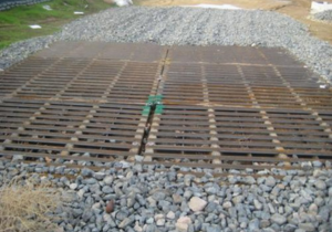 Coarse gravel and shaker rack at entrance of construction site