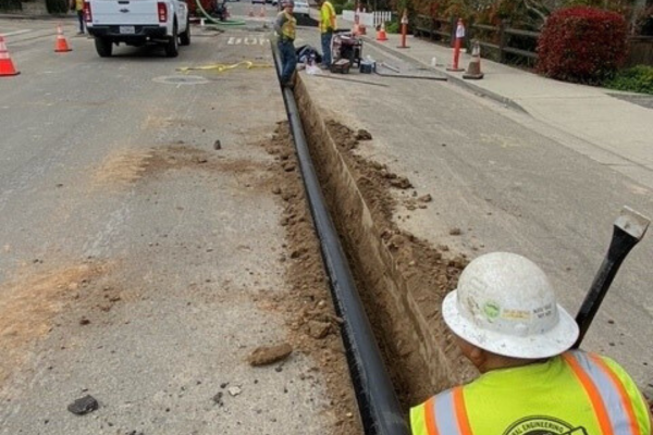 A picture of a construction worker working on the Johnson Avenue Waterline Replacement project