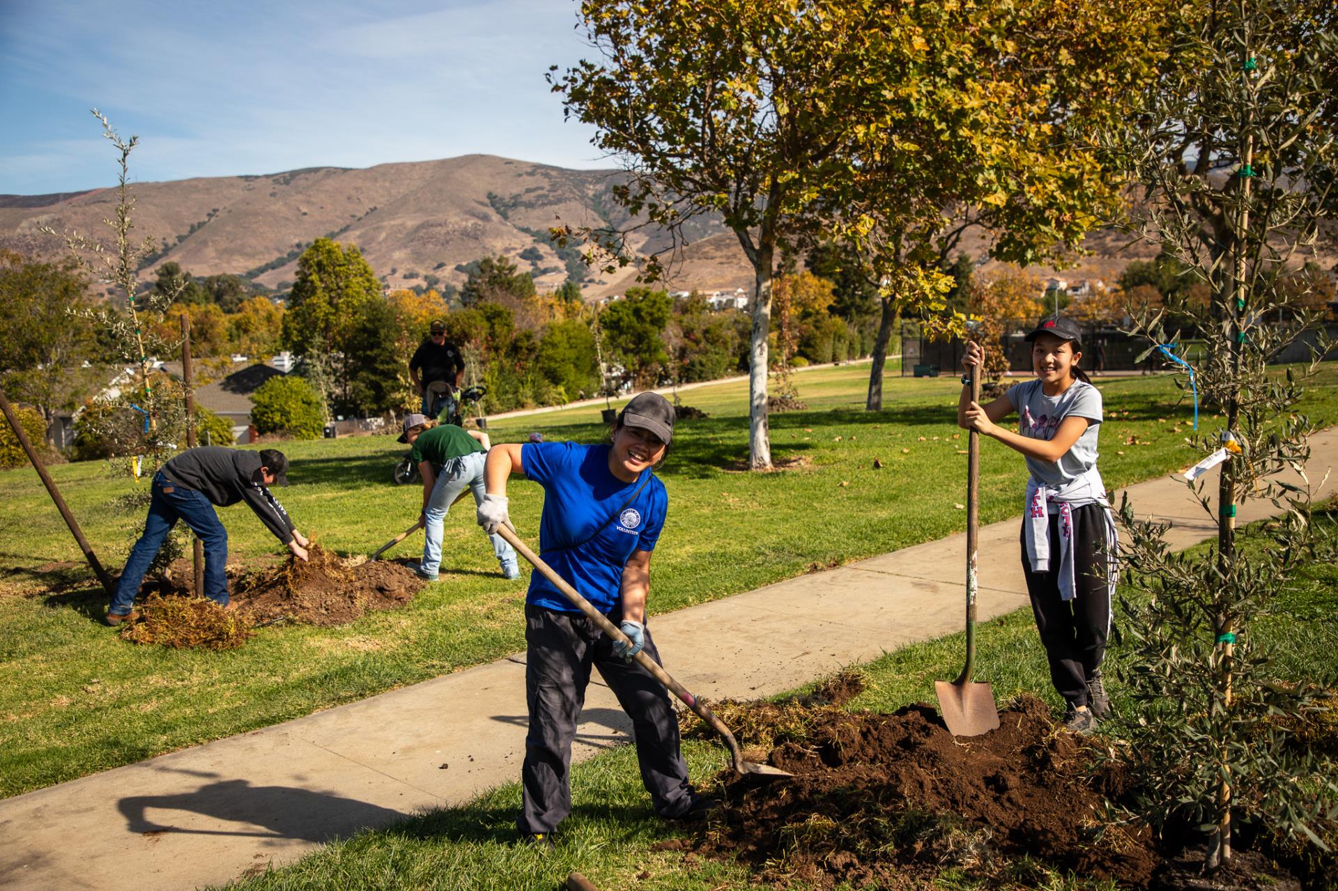 Volunteers plant trees at a park on Arbor Day 2023.