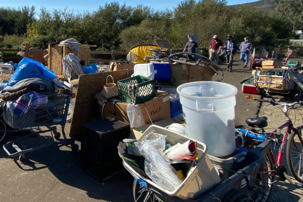 A large collection of items and trash at an encampment.