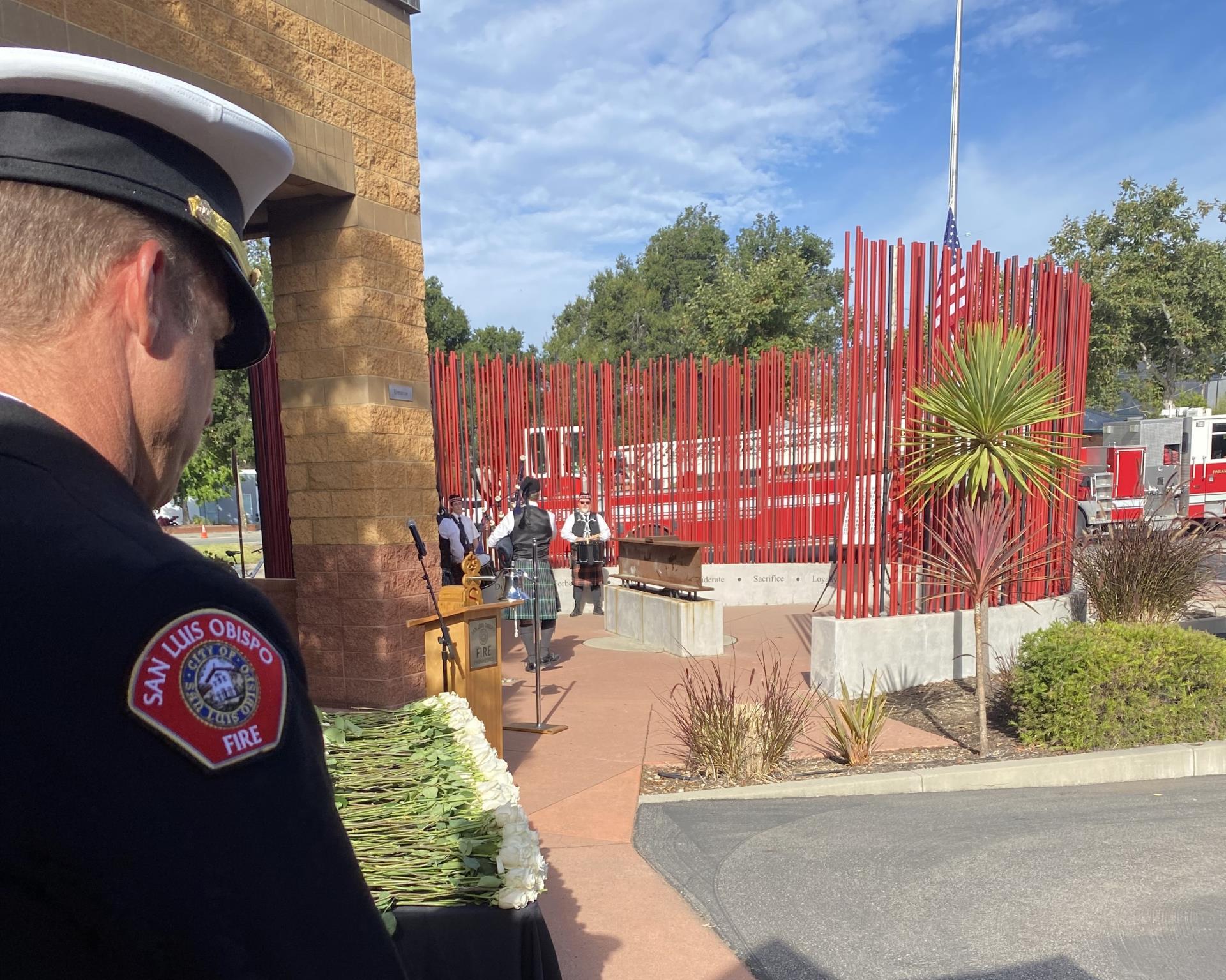 A firefighter stands in front of the local 9/11 Memorial site.