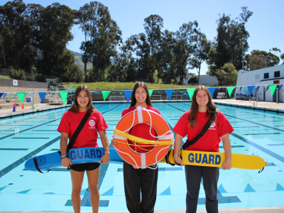 An image thumbnail of 3 lifeguards posing in front of the mail pool at the SLO Swim Center