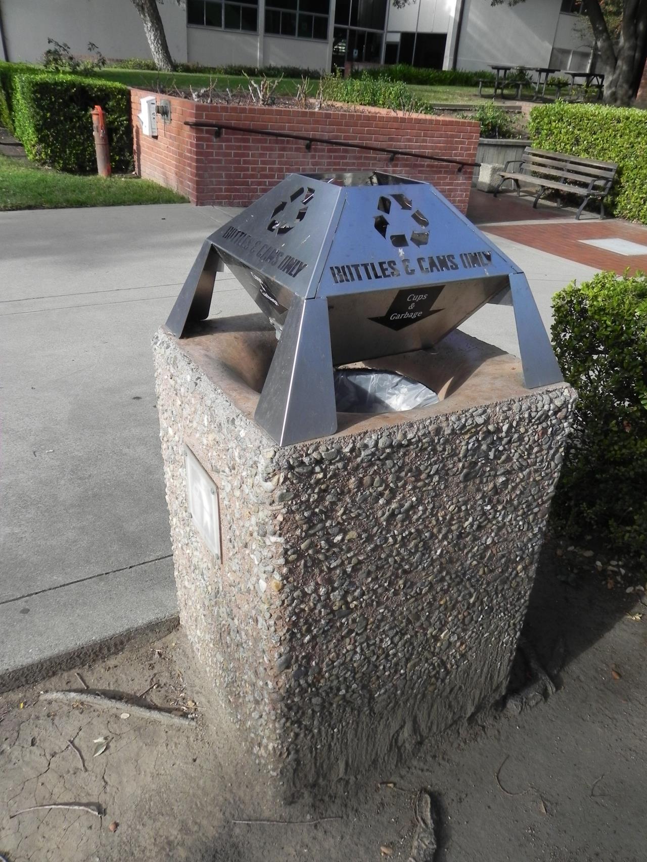 photo of concrete public trash can