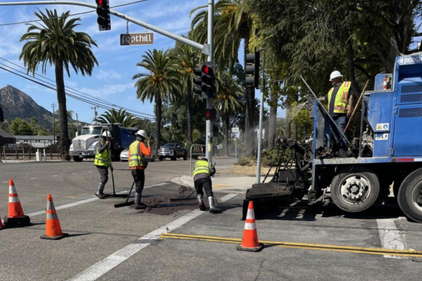 A picture of construction crews working on slurry sealing Foothill Boulevard in San Luis Obispo