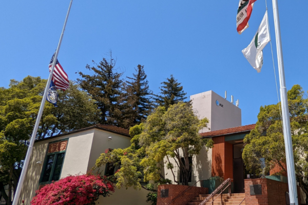 The front entrance of City Hall with the flags at half staff