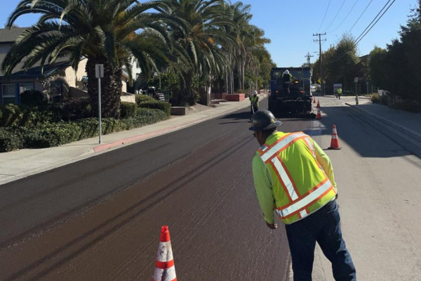 A picture of a construction crew applying slurry seal in San Luis Obispo as a part of SLO in Motion