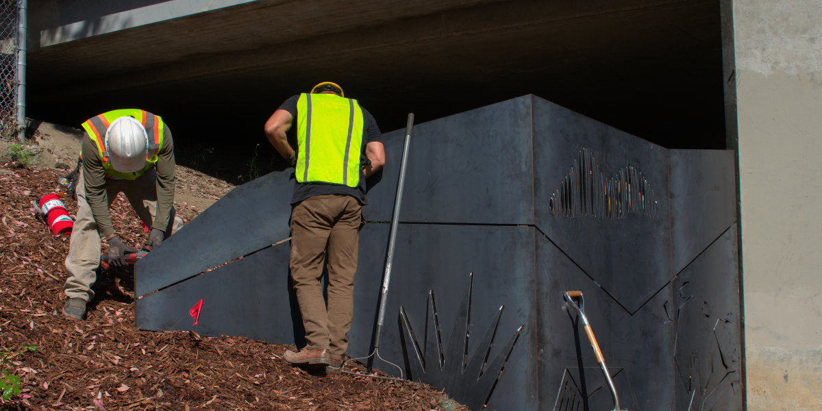 A picture of the Chorro Street Underpass Art Fence being installed