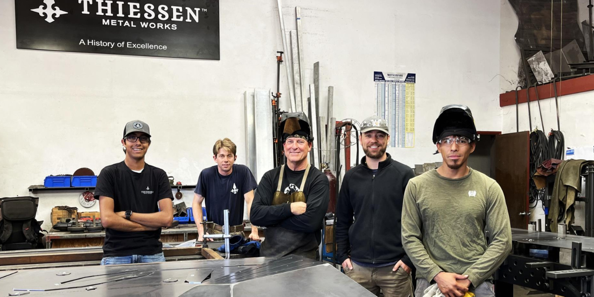 A picture of Thiessen Metal Works preparing to install their Art Fence for the City of San Luis Obispo