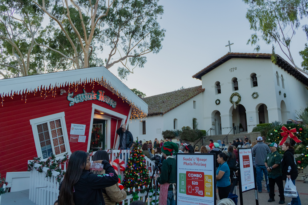 A crowd gathers in front of Santa's House at Mission Plaza. 